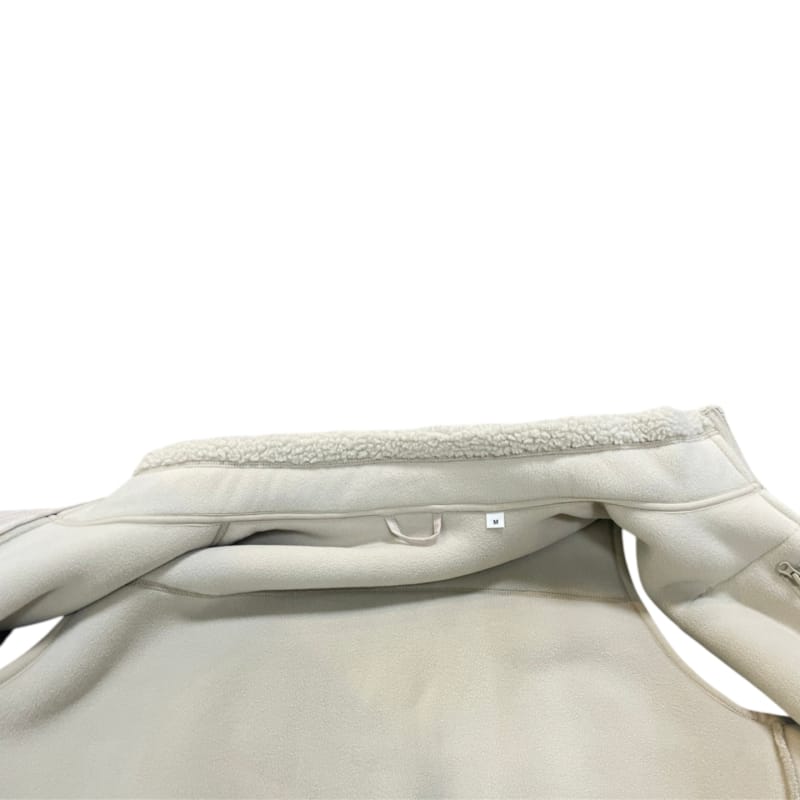 Inside view beige sherpa fleece vest, fleece lining, inner neck size label
