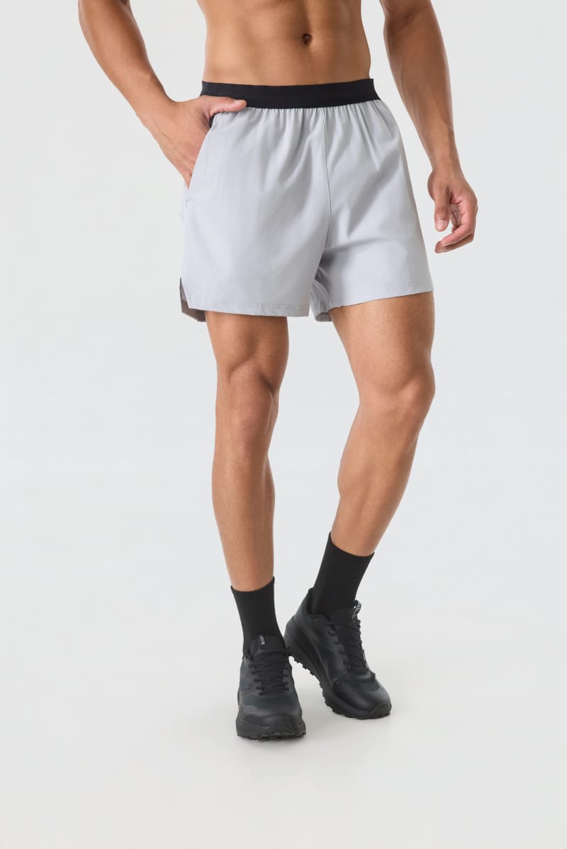 Male model wearing Tensuit light grey quick dry athletic running shorts front view