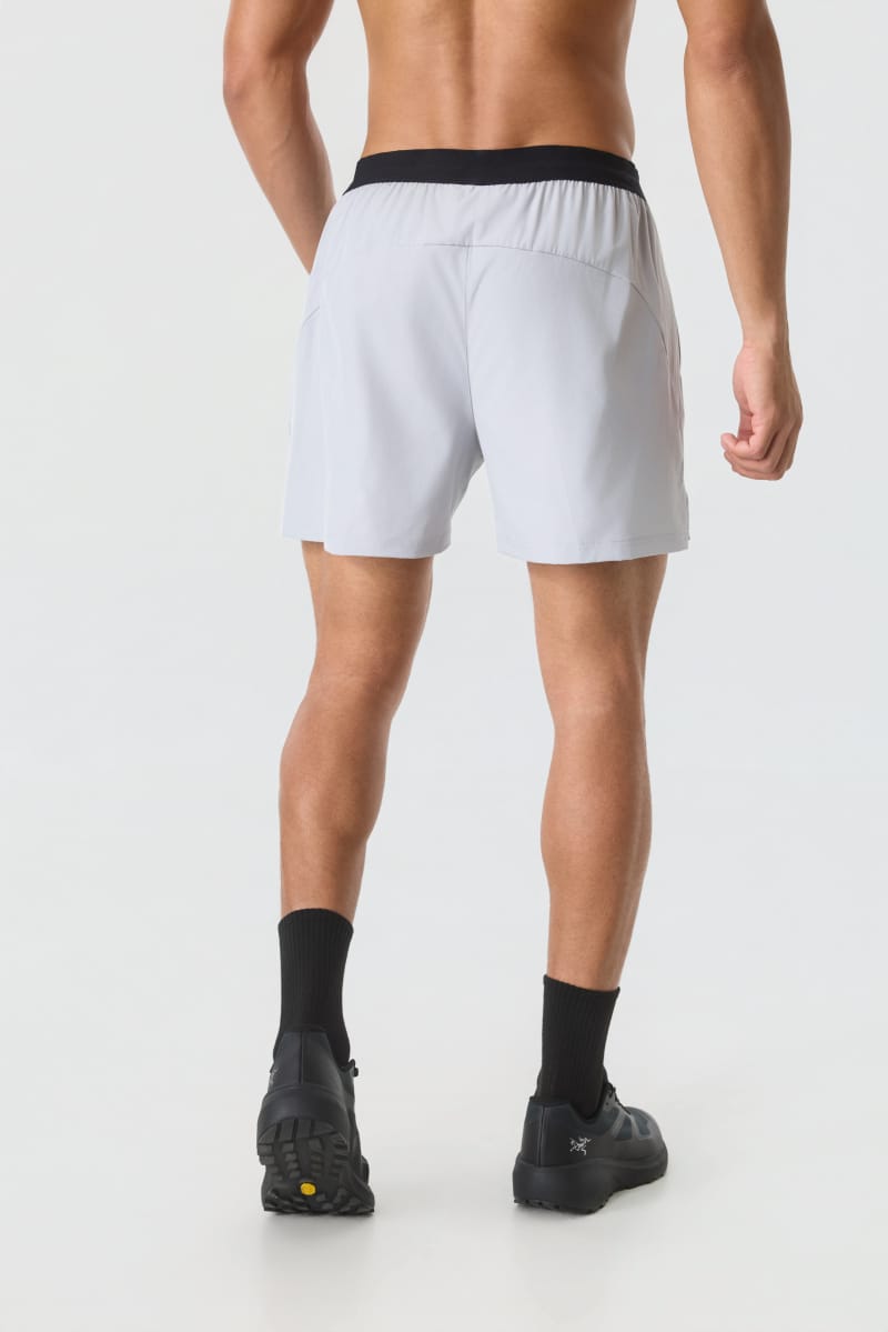 Male model wearing Tensuit light grey quick dry athletic running shorts back view