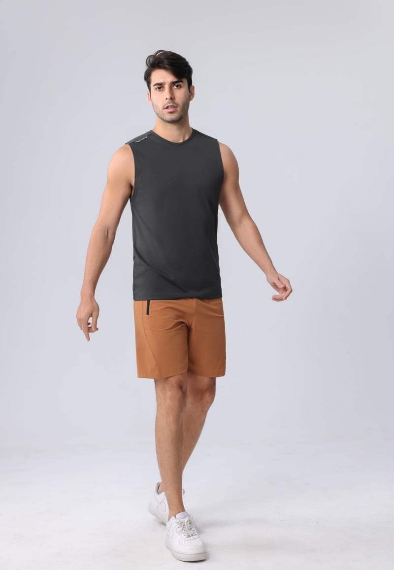 Male model wearing Tensuit B69D brown hiking shorts with dark grey sleeveless tank top