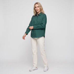 Woman wearing Tensuit unisex dark green 100% combed cotton long sleeve button down shirt, studio shot