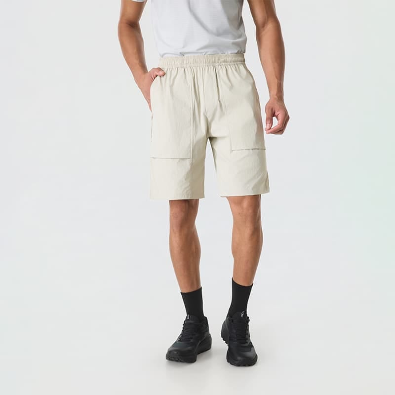 Male model wearing Tensuit beige outdoor cargo shorts front view